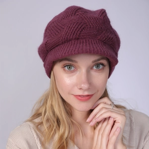 Close-up of deep purple cable knit beret cap with peak, featuring thick warm texture