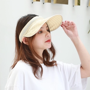 Detail of light yellow sun visor with striped brim and breathable knit fabric for women