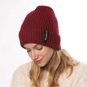 Close-up of deep red ribbed knit beanie with Breakout label and warm wool texture