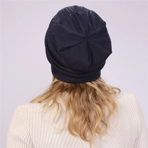 Detail of navy cotton slouchy beanie showing delicate rhinestone accents and soft texture