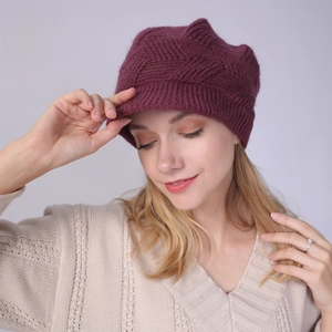 Detail of burgundy ribbed knit beanie with fuzzy texture and visor for winter warmth