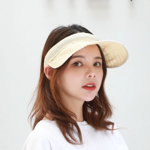 Detail of a beige sun visor headband with sparkling silver letter motifs and striped brim
