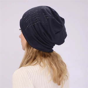 Detail of dark blue slouchy beanie with silver rhinestones and premium knit texture