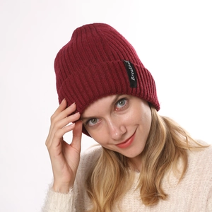 Detail of the Breakout letter label on a burgundy ribbed knit wool warm winter beanie