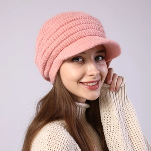 Close-up of pink striped knit peak cap with soft brim and warm chunky texture