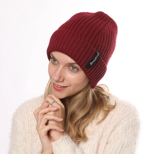 Detail of dark red ribbed knit beanie featuring the Breakout logo patch for winter