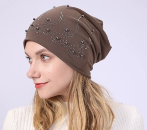 Detail of coffee brown cotton slouchy beanie with elegant pearl and rhinestone patterns