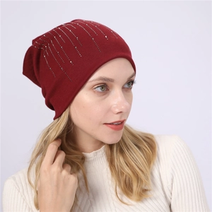 Close-up of burgundy cotton slouchy beanie featuring vertical silver rhinestone patterns