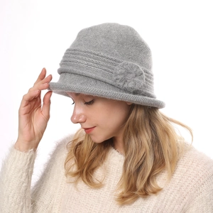 Detail of gray faux rabbit fur knitted cloche hat featuring a 3D floral accent and soft texture