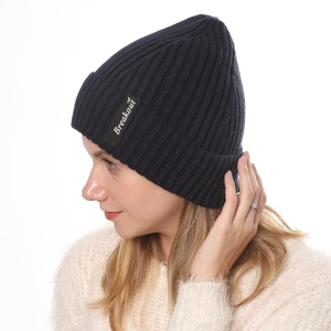 Detail of navy blue ribbed knit beanie featuring the Breakout logo patch on the side