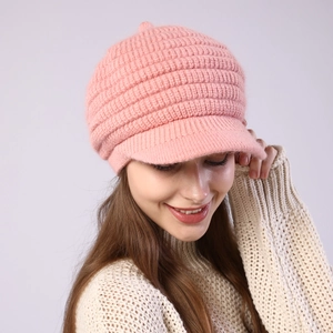 Close-up of pink striped knit peak cap with thick ribbed texture and warm fleece lining