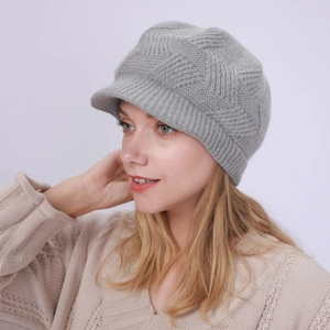 Detail of grey knitted peak beanie with three-dimensional diamond pattern texture