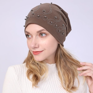 Close-up of brown cotton beanie featuring elegant silver rhinestone and bead scrollwork
