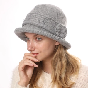 Close-up of grey knit bucket hat with decorative flower detail for winter warmth