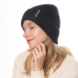 Close-up of navy blue ribbed knit beanie featuring the Breakout fabric label