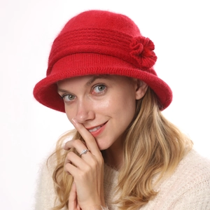Close-up of a red rabbit fur knit bucket hat featuring a decorative 3D flower detail