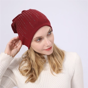 Detail of burgundy cotton slouchy beanie with sparkling vertical rhinestone patterns