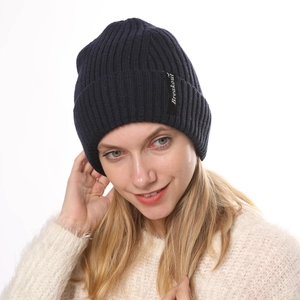 Detailed texture of dark blue ribbed knit beanie with Breakout embroidered patch label