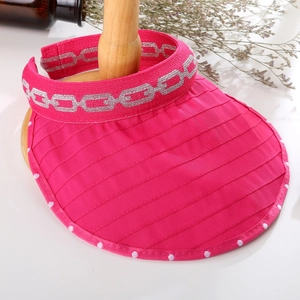 Close-up of rose red sun visor with silver chain pattern and wide brim texture