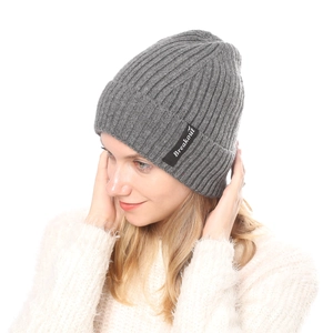 Close-up of grey ribbed knit beanie featuring black Breakout label on a cozy texture