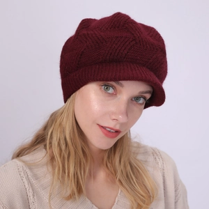 Detail of burgundy twill knit visor hat with soft rabbit fur texture for winter warmth