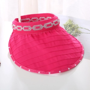 Macro shot of rose red sun visor featuring striped fabric texture and silver chain pattern