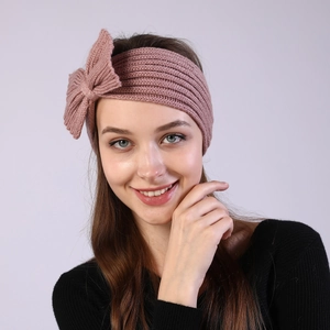 Detail of pink knitted bow headband for women showing soft texture and high elasticity