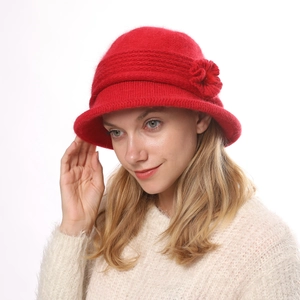 Detail of red knit flower bucket hat featuring warm fleece lining and thick wool texture
