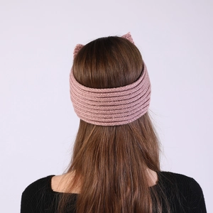 Detail view of pink knitted headband with cat ears on model back for women