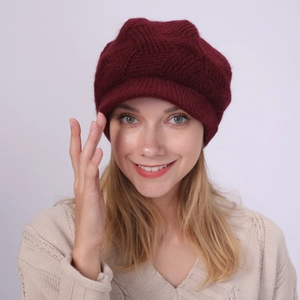 Close-up of wine red twill knit peak cap with warm plush lining and soft faux rabbit fur