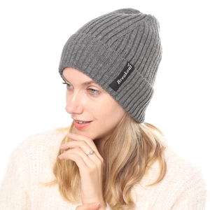 Close-up of Breakout label on dark grey ribbed knit beanie for winter warmth