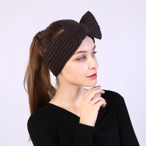 Detail of dark brown bow knit headband showing thick ribbed texture and vintage style