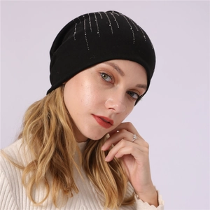 Detail of a black slouchy beanie with sparkling silver rhinestones on soft cotton fabric