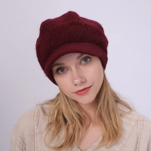Close-up of wine red twill knit beanie with visor showing soft wool-like texture