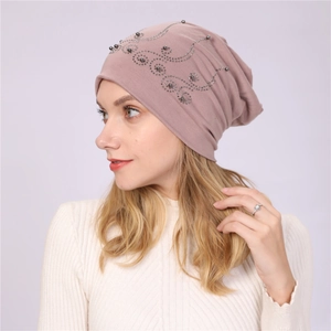 Detail of dusty pink double-layer cotton beanie with decorative pearls and rhinestones