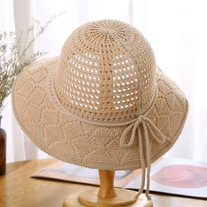 Women's foldable crochet sun hat with a bow detail and wide brim for beach use