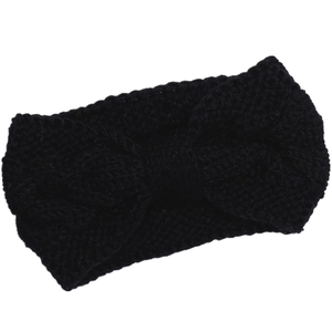 Detailed close-up of a black cable-knit headband with a central twist bow design