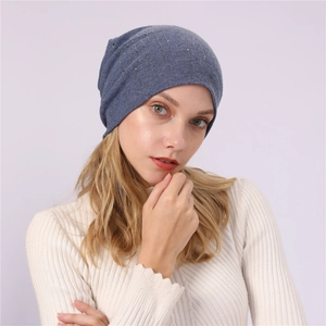 Detail of blue cotton beanie featuring vertical rhinestone patterns and soft knit texture