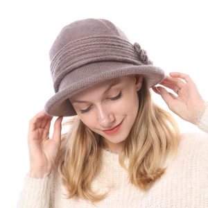 Detail view of the floral knit bucket hat with warm wool texture and thick brown yarn