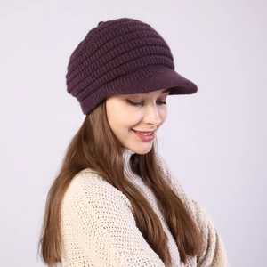 Close-up of dark purple striped knit visor hat texture and warm winter material
