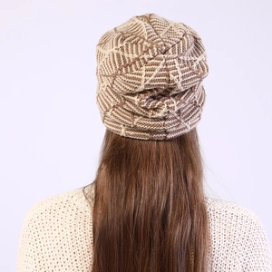 Detail view of winter knitted slouchy beanie with brown and beige diamond grid pattern