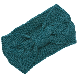Close-up of teal knit headband with chunky cable stitch and elegant twist knot detail