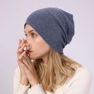 Close-up of cotton beanie featuring silver rhinestone patterns on blue-gray knit fabric
