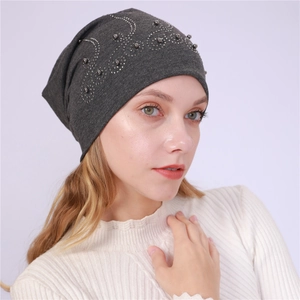 Detailed view of dark grey cotton beanie with silver beads and rhinestones floral pattern