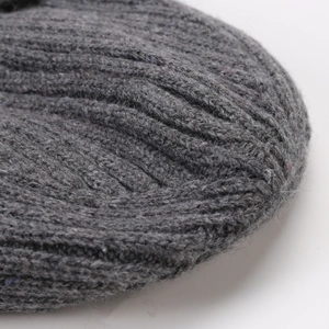 Detailed macro view of dark grey ribbed knit texture on warm winter beanie hat
