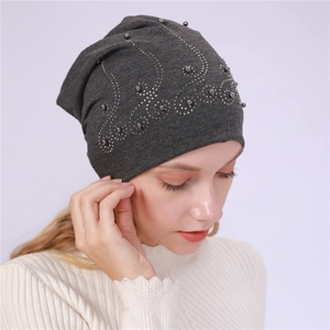 Detailed view of dark grey cotton beanie featuring elegant pearls and shiny rhinestones