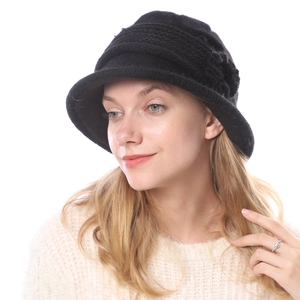 Detail of black knitted flower cloche hat with thick faux fur texture for women