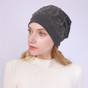 Close-up of a dark grey cotton slouchy beanie with elegant silver rhinestone wave patterns
