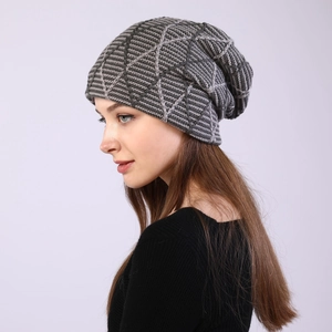Detail of grey knitted beanie showing geometric star texture and soft thermal lining