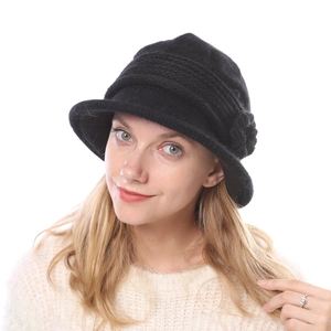Detailed texture of women's thick winter knit hat with a side flower and brim detail